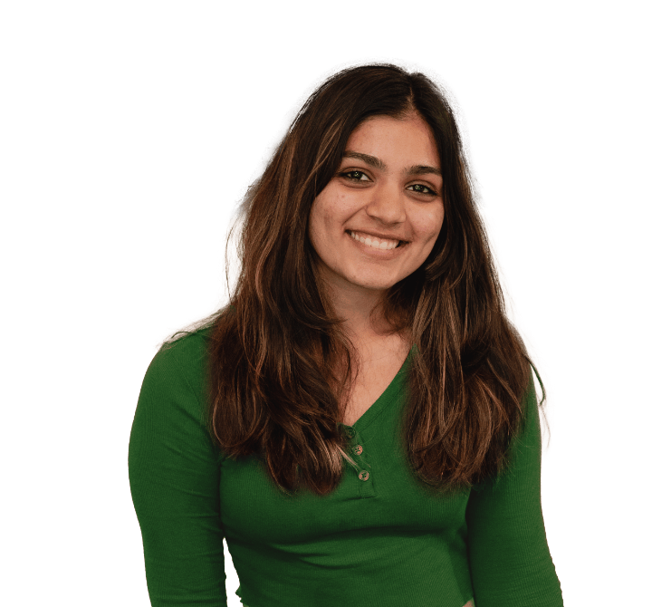 A person with long brown hair, wearing a green long-sleeve shirt, is smiling at the camera against a plain background, perfect for a welcoming homepage slide.